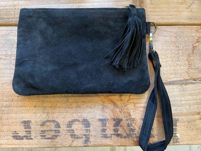 A black suede clutch bag handmade in Morocco. With an oversized tassel to the zip puller and a detachable wrist strap. 
