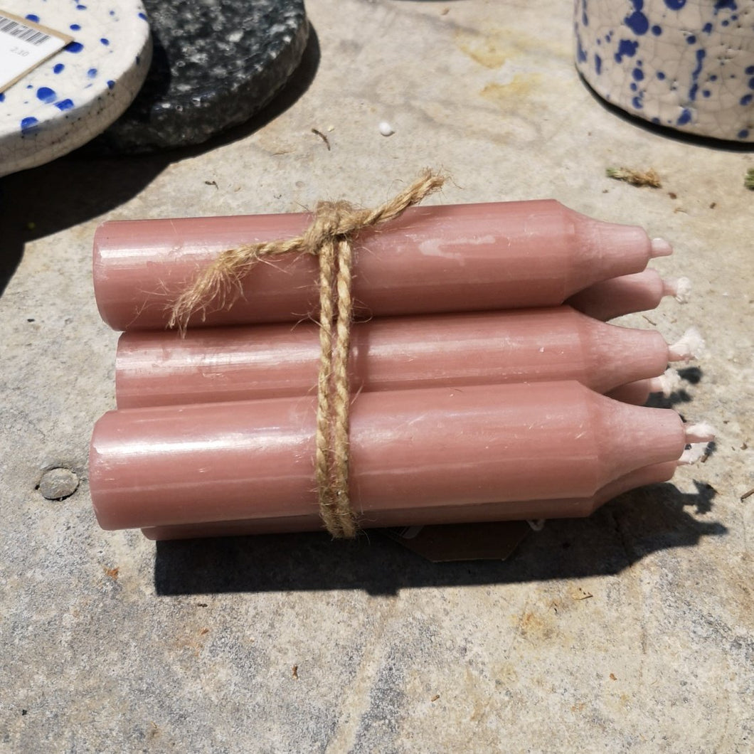 short rose coloured rustic look candles