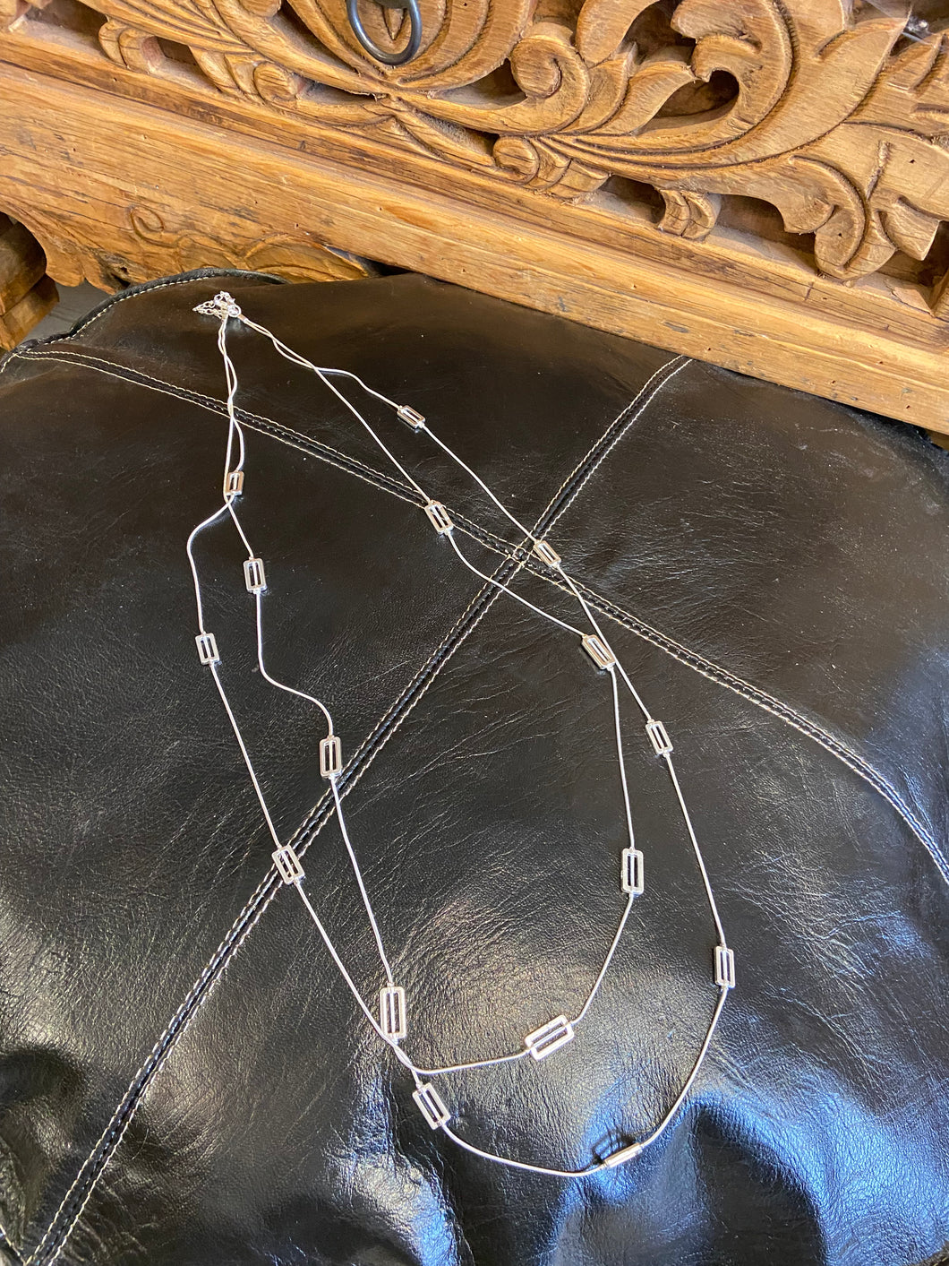 geometric multi row necklace, approxiately 54cm in length at longest point. clasp fastening to the back. silver in colour and can be worn day or night. 