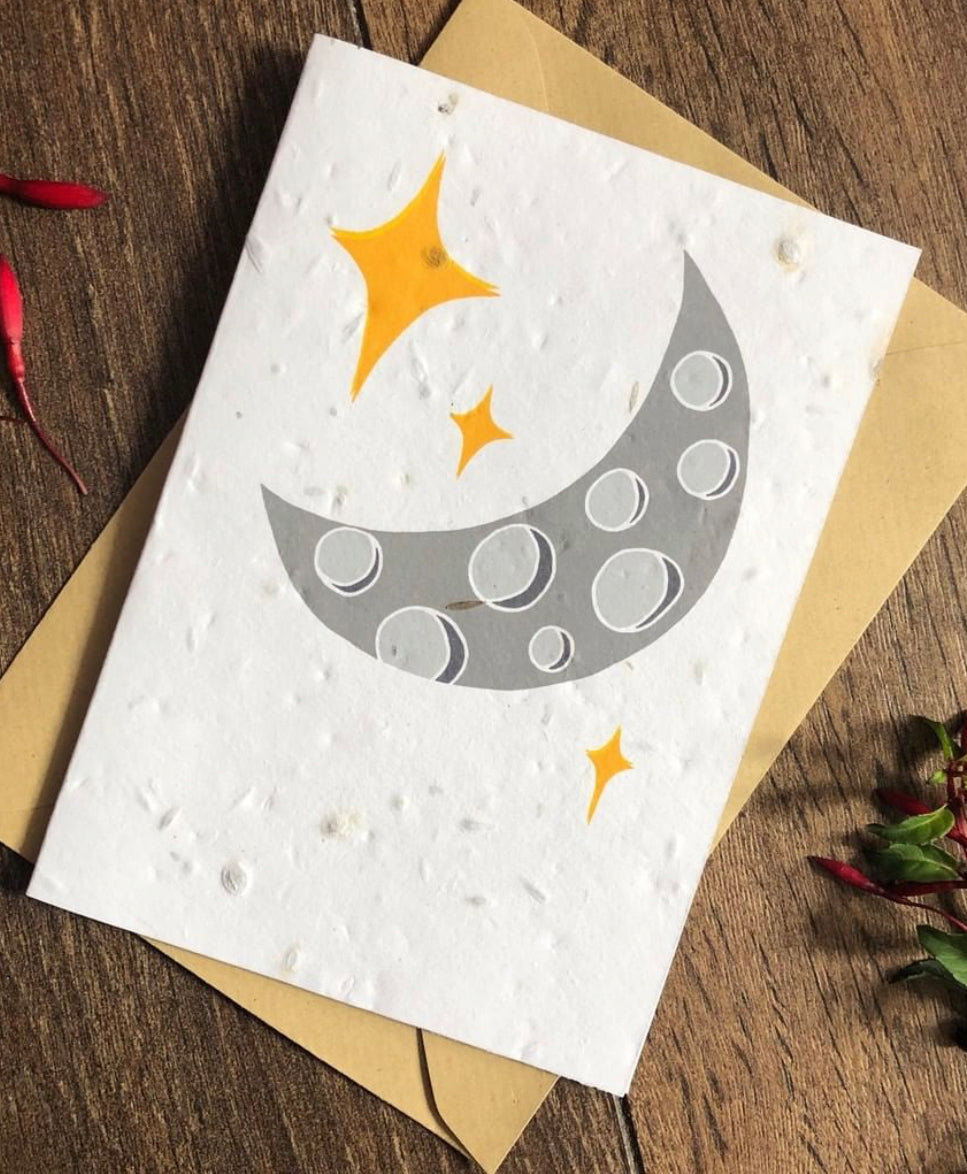 A card with an image of a large moon and stars filled with wild flower seeds