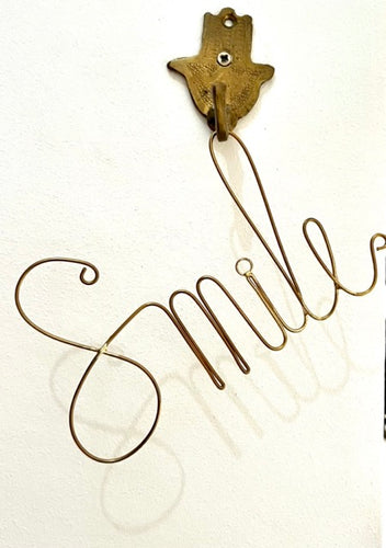 Smile - handmade brass wire word to hang or sit on a shelf