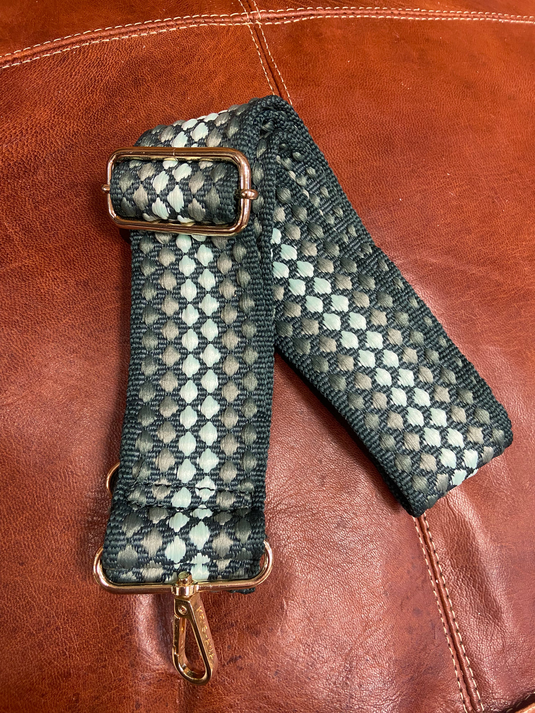 A bag strap which can be added to your bag of choice to personalise your look. Green, with various shades, and a spot design, it will coordinate with many colours. Fully adjustable, and with gold coloured metal hardware. 