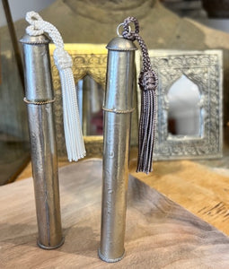 This beautiful perfume spray bottle is the perfect size to pop in your handbag. It is made from a glass bottle with a small plastic spray pump and is completely encased in hammered metal and has a lid with a hook for a tassel on it.
