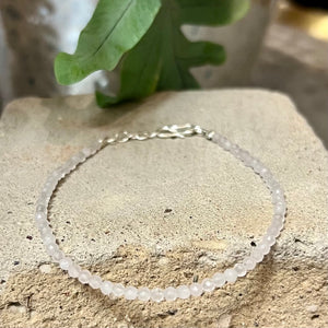 A delicate bracelet of rose quartz beads with sterling silver closure