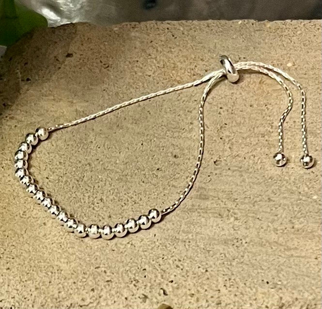 This sterling silver beaded bracelet has 20 little circular beads on it and will suit anyone. These beads are on a snake bracelet.