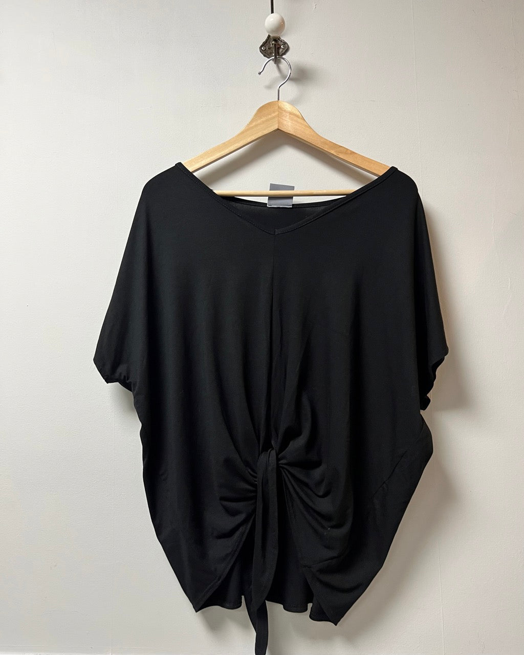 Black v neck loose fit jersey top with a tie front