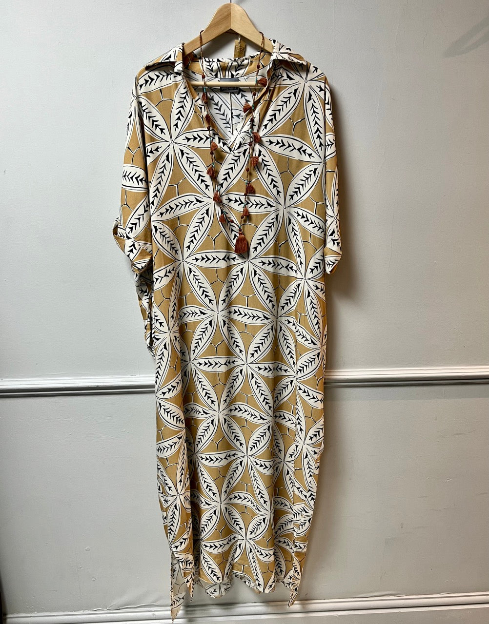 A collared tunic dress in turmeric with bold flowers white and additional black detail