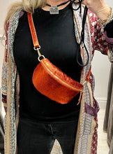Load image into Gallery viewer, Zip up crossbody half moon bag in vibrant metallic orange