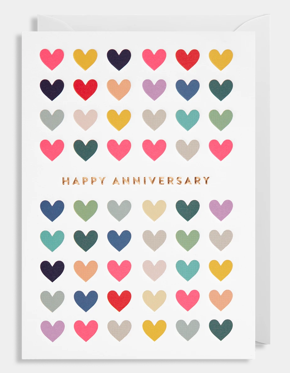 Happy Anniversary in gold in the middle of a whole card full of different coloured hearts