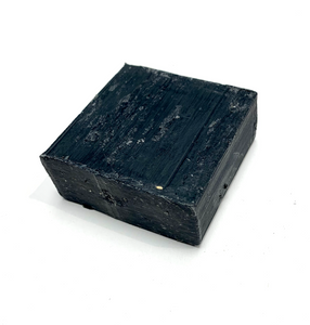 Black small square bar of soap with texture and fragranced with black pomegranate