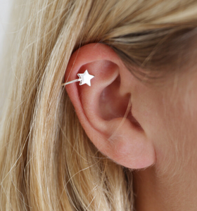 A delicate star ear cuff crafted from sterling silver