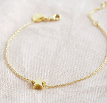 Load image into Gallery viewer, A golds tar charm on a fine chain bracelet with an extender chain.