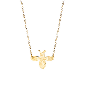 A handout and hammered brass bee on a gold plated chain.