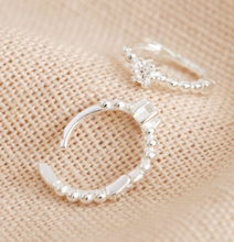 Load image into Gallery viewer, small sterling silver huggie hoops with a crystal