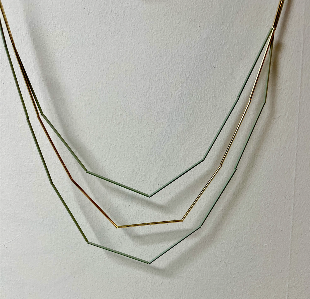 Sage Geometric Long necklace made up of tiny long tubular metal beads threaded together to create a spectacular necklace