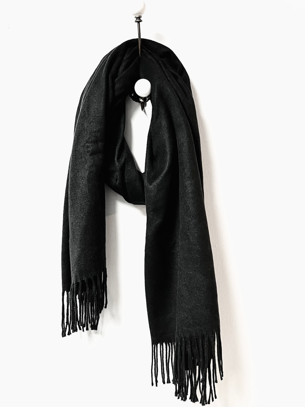A simple and stylish black fringed scarf in a very cosy and soft fine blanket finish. 175cm X 75cm
