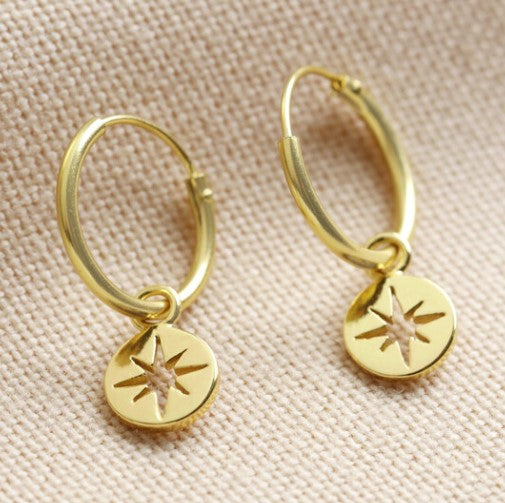 These hoop earrings feature a disc to the bottom with a tiny shooting star within. In gold plated sterling silver, wear them on their own, or layer up and create a curated ear. 