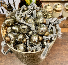 Load image into Gallery viewer, Antique Silver recycled baubles handmade in India with an antique brass top and hanging on a grey velvet tie.