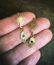 Load image into Gallery viewer, delicate handmade brass hand and star dangling earrings have a star on one hand and a heart on the other and a beautiful sunshine above. On gold plated hooks