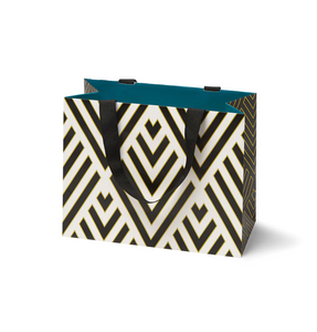A gift bag with a black, white and gold geometric pattern and black ribbon handles
