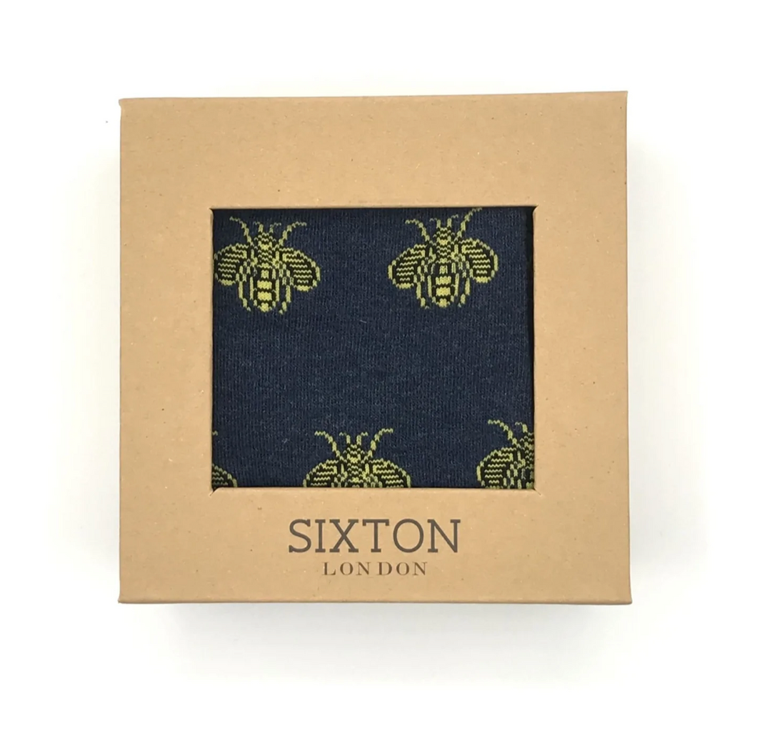 A pair of mens navy blue socks with a yellow bee design on them. Presented in a natural card box.