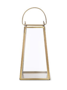 This elegant lantern is made from brass. It features glass sides, and to the top there is a brass handle which can be lifted up or down. The lantern has a flat base so candles can be stood inside, and to the underneath there is a black felt base so it can stand on a table or mantelpiece