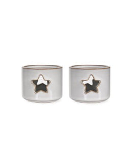 In a soft white ceramic glaze, this pair of tea light holders are small in size. Just the right size for that tea light. With a star cut out front and back they will glow when the candle is lit.