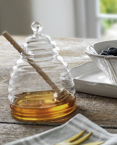 a ridged glass honey pot with a lid. a beech dibber comes with to complete the set, and to drizzle your honey with ease.
