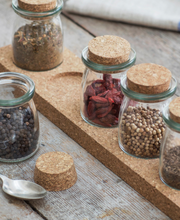 Load image into Gallery viewer, A set of 5 glass storage jars with cork lids and a cork stand