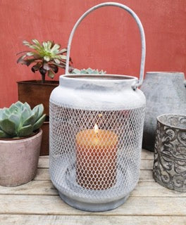 A simple lantern with clean lines and a simple mesh design in a soft grey.