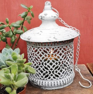 A rustic lantern with antique detail and a chain and hook to hang it. 28 X 19 cm 