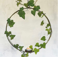 Load image into Gallery viewer, Circular florists ring with a votive at the base. Made in a rust effect hanging on a chain.