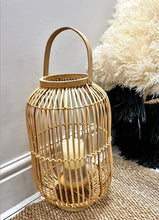 Load image into Gallery viewer, A large natural lantern made from rattan with a metal stand and glass surround for the candle
