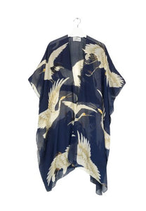 a lightweight fabric featuring a large oversized stork print with a navy background. a throwover kimono style with loose sleeves and an open front.