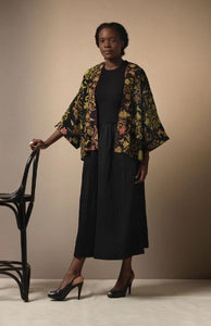 A bestselling kimono from One Hundred Stars in a print, with a black background, and an all over print. Loose 3/4 sleeves and an open front with a lightly embroidered lapel. 