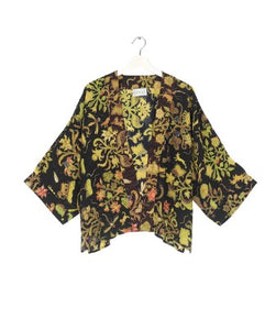 A bestselling kimono from One Hundred Stars in a print, with a black background, and an all over print. Loose 3/4 sleeves and an open front with a lightly embroidered lapel.
