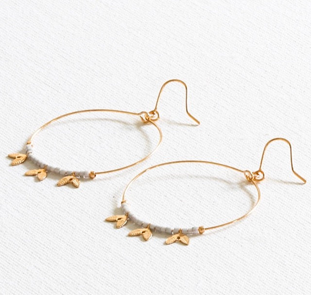 These pretty delicate gold wire hoops have iridescent white beads and tiny leaves interspersed along the base of the hoop. They make a gorgeous gift and will suit anyone.