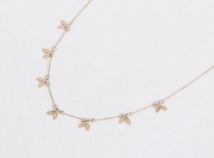 This pretty delicate gold chain necklace has iridescent white beads and tiny leaves interspersed along it. It will make a gorgeous gift and will suit anyone.