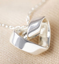 Load image into Gallery viewer, A twisted infinity heart in silver to signify true love 