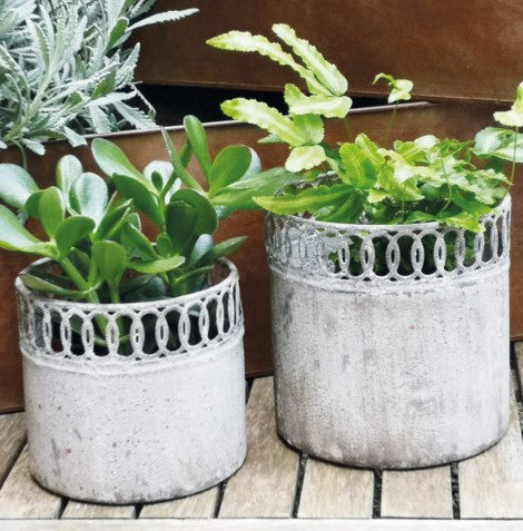 A metal indoor plant pot, with an antique finish,. An openwork cutwork detail to the top makes these pots so decorative and lovely in your home. 