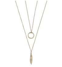 Load image into Gallery viewer, A long ladies necklace in a gold colour. A double strand necklace but attached together for the ease of just putting on one necklace but having a layered look. The longest chain features a leaf shape pendant and the shorter chain a circular pendant. With clasp fastening anf extender chain. 
