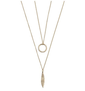 A long ladies necklace in a gold colour. A double strand necklace but attached together for the ease of just putting on one necklace but having a layered look. The longest chain features a leaf shape pendant and the shorter chain a circular pendant. With clasp fastening anf extender chain. 