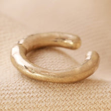 Load image into Gallery viewer, A matte gold hoop ear cuff, simply perfect for simply over your ear if you haven&#39;t got a helix piercing. In an organic textured finish.