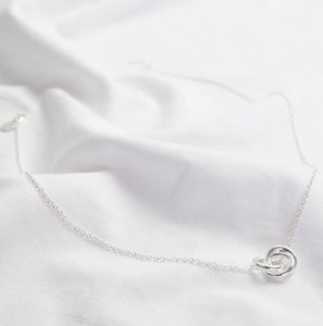 A fine chain with a triple ring pendant to the front. The three rings intertwine and create a lovely shaped pendant. With lobster clasp fastening and extender chain so you can choose your preferred length. Sterling silver plated brass.