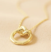 Load image into Gallery viewer, This 14ct gold plated ladies necklace features an organic-shaped circle, complete with an infinity knot. The pendant has a delicate chain threaded through the loop which fastens with a lobster clasp for easy securing.