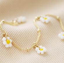 Load image into Gallery viewer, Made from 14ct gold plated brass, it features white and yellow bead daisy charms which dangle from the chain. The chain is a satellite style with a lobster clasp and a 3cm extender chain for adjustable wearing.