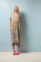 Load image into Gallery viewer, A midi length dress in a beautiful soft and elegant print based on Tudor silk embroidery. The background of the dress is pale grey blue with neutral tones to the print with subtle hints of pink and blue. A midi length, dropped shoulder short sleeve, V neck and pleat to front neck. One size. 