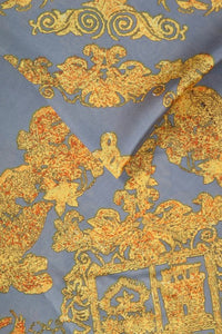 A ladies scarf measuring 110cm x 110cm in a grey and mustard baroque style print. Super soft and silk like drapey fabric.