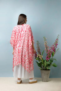 In an Ikat pink print design, this lightweight ladies throwover is delicate in nature. It drapes beautifully and is worn loose. With loose arms and a front which can be tied.