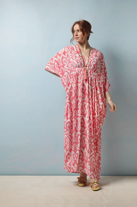 With its bohemian floor-length fit, this kaftan flatters all body shapes – an empire line bust with ¾ length drop shoulder sleeves, V-neck and front subtle gathering that defines your figure without compromising on comfort.  In a traditional Ikat pink print. 